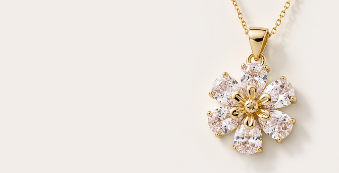 Dije Gold Filled en forma de flor con piedras brillantes